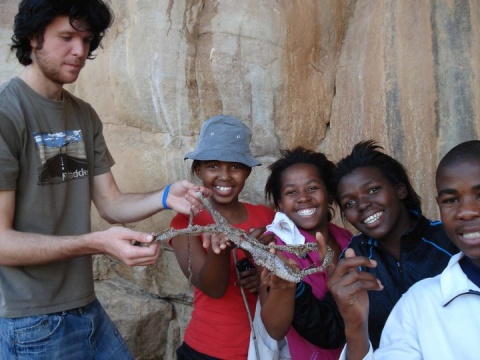 Lorna (second from left) holding a reptile's skin with her peers.